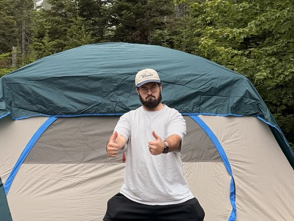 Alex giving two thumbs up in front of our tent